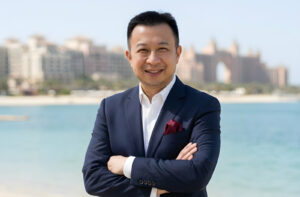 Jack Yan wearing a shirt and navy blazer.