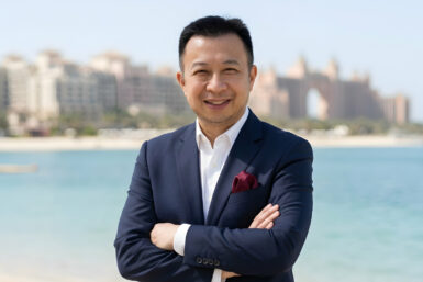 Jack Yan wearing a shirt and navy blazer.